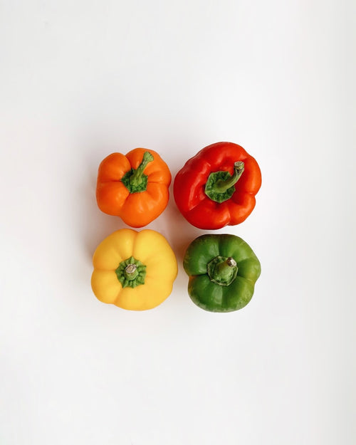 Fresh colorful bell peppers on white background